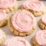 Crumble Sugar Cookie recipe: A batch of freshly baked and frosted pink sugar cookies.
